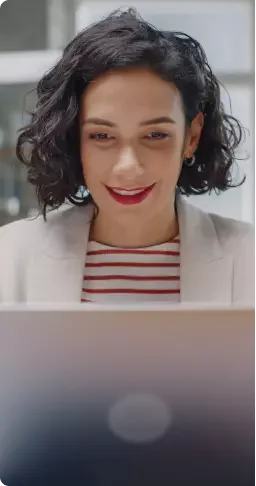 mulher utilizando notebook e sorrindo